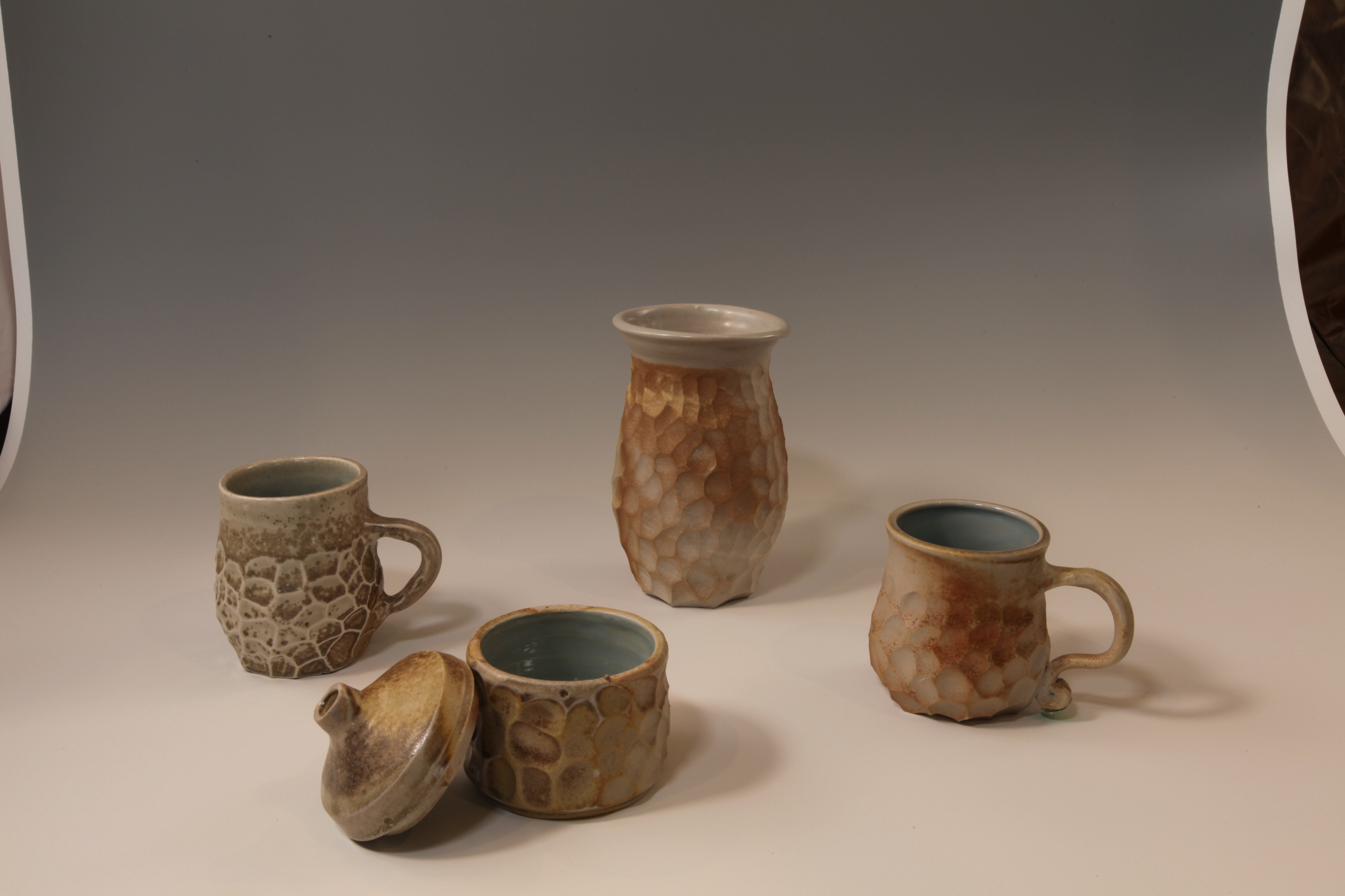 Carved stoneware set — mugs, platter and pitcher